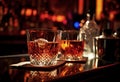 Cocktail Negroni with ice and orange peel in two tall vintage retro crystal cut glasses at the bar.