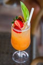 Cocktail of orange juice in glass with strawberries and apple, selective focus Royalty Free Stock Photo