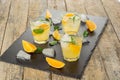 Cocktail. Orange juice with mint and ice on rustic wooden table Royalty Free Stock Photo