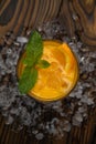 Orange juice with mint and ice rustic wooden table Royalty Free Stock Photo