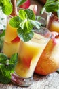 Cocktail with pear vodka, apple juice, mint and cinnamon, vintage wooden background, selective focus Royalty Free Stock Photo