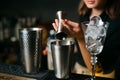 Cocktail preparation. bartender coocks a beverage at bar counter