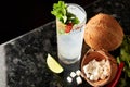 Cocktail with rum, coconut, cilantro, lime and chilli pepper