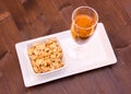 Cocktail and salted nuts on wood from above Royalty Free Stock Photo