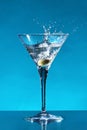 Cocktail with splashing olive Royalty Free Stock Photo