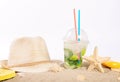 Cocktail, straw hat, beach slippers, lotion, starfish on the san Royalty Free Stock Photo