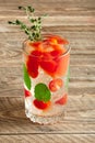 Cocktail with vodka, tomato, mint and ice cubes