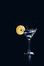 Cocktail water drink splash in the glass with lemon Isolated on black Royalty Free Stock Photo