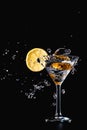 Cocktail water drink splash in the glass with lemon Isolated on black Royalty Free Stock Photo