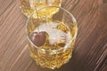 Cocktail from whisky with cherry in two glasses on a wooden back Royalty Free Stock Photo