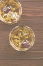 Cocktail from whisky with cherry in two glasses on a wooden back Royalty Free Stock Photo