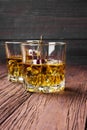 Cocktail from whisky with cherry in two glasses on a wooden back Royalty Free Stock Photo