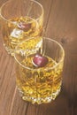 Cocktail from whisky with cherry in two glasses on a wooden back Royalty Free Stock Photo