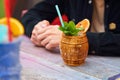 Cocktail in a wooden barrel glass on the table