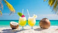 Cocktails and coconuts on tropical beach with palm trees and turquoise sea in the background Royalty Free Stock Photo