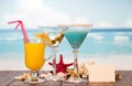 Cocktails juice and starfishes Royalty Free Stock Photo