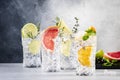 Cocktails set. Alcoholic drinks with gin, tonic, lime, lemon, grapefruit, orange, cucumber, soda and spicy herbs in wine glasses,