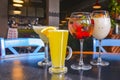 Cocktails on the table. Different coloured drinks in different glasses on dark wooden table Royalty Free Stock Photo