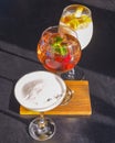 Cocktails on the table. Different coloured drinks in different glasses on dark wooden table. Royalty Free Stock Photo