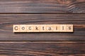 cocktails word written on wood block. cocktails text on cement table for your desing, concept