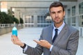 Cocky businessman holding a potion Royalty Free Stock Photo