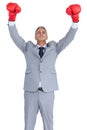 Cocky businessman posing with red boxing gloves Royalty Free Stock Photo
