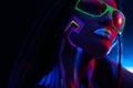 Cocky Girl with Dreadlocks in Ultraviolet neon light with Foggy Background. Bodyart