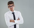 Shrugging it off.... A cocky young man standing with his arms folded looking at the camera defiantly. Royalty Free Stock Photo