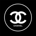 Coco Chanel. The popular Chanel logo in white over black background.