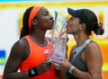 Coco Gauff (L) and Jessica Pegula of USA pose with the trophy after the women's doubles final at 2023 Miami Open