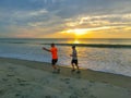 Cocoa beach, Florida, USA - April 29, 2018: Men running on the beach at sunset. Florida, USA Royalty Free Stock Photo