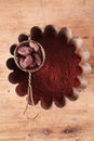 Cocoa beans in sieve with cocoa powder