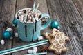 Cocoa in a blue mug with marshmallows, chocolate and christmas cookies