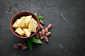 Cocoa butter in a bowl on the old background. Cocoa beans. Top view.