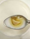 Cocoa butter melting on the spoon with milk