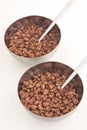 Cocoa coated puffed rice in metal bowls on white