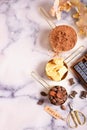 Cocoa, cocoa butter and cocoa beans, chocolate in gold containers on a marble surface. Flat lay. Place for text.