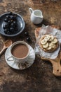 Cocoa, cracker with peanut butter, banana, flax and chia seed, grapes - snack, breakfast table. Cosy atmosphere breakfast on wood Royalty Free Stock Photo