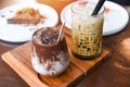 Cocoa drink chocolate and Bubble milk tea or Taiwan milk tea in glass on the wooden table with cake