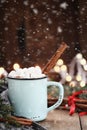 Cocoa with Marshmallows and Cinnamon Bark with Falling Snow Royalty Free Stock Photo