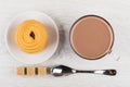 Cocoa with milk in cup, cookies in saucer, sugar cubes