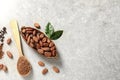 Cocoa pod, beans and powder on light table. Space for text Royalty Free Stock Photo