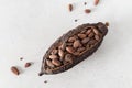 Cocoa pod with cocoa beans on a white concrete background. Organic food. Natural chocolate. Top view. chocolatier, confectionery.