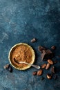 Cocoa powder, beans and dark chocolate pieces crushed, culinary background Royalty Free Stock Photo