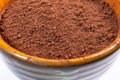 cocoa powder in a bowl shot on a macro lens, powder for making chocolate. Royalty Free Stock Photo