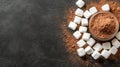 Cocoa powder in a bowl with white marshmallows scattered on dark textured surface. Royalty Free Stock Photo