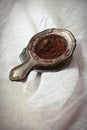 Cocoa powder in old vintage sieve