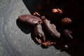 Cocoa whole toasted beans ready for handmade chocolate preparation in a mortar.