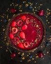 Coconut bowl with cherries and strawberries smoothie