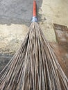 Coconut broom stick on brick wall Royalty Free Stock Photo